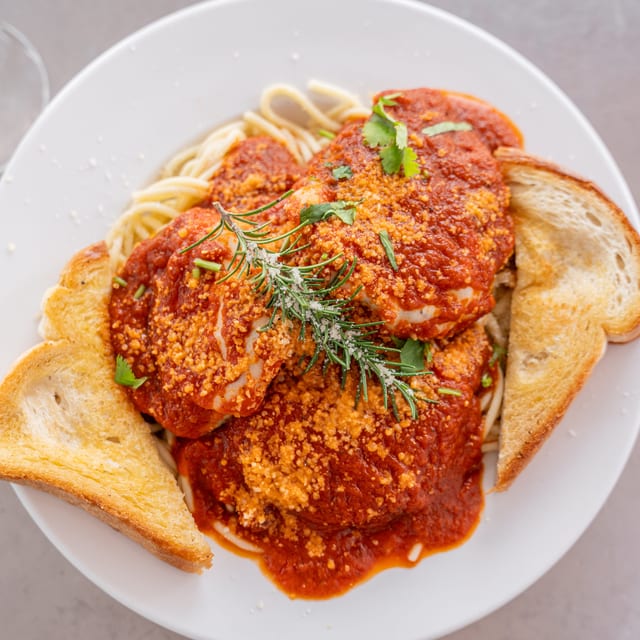 Chicken Parmesan Over Spaghetti.